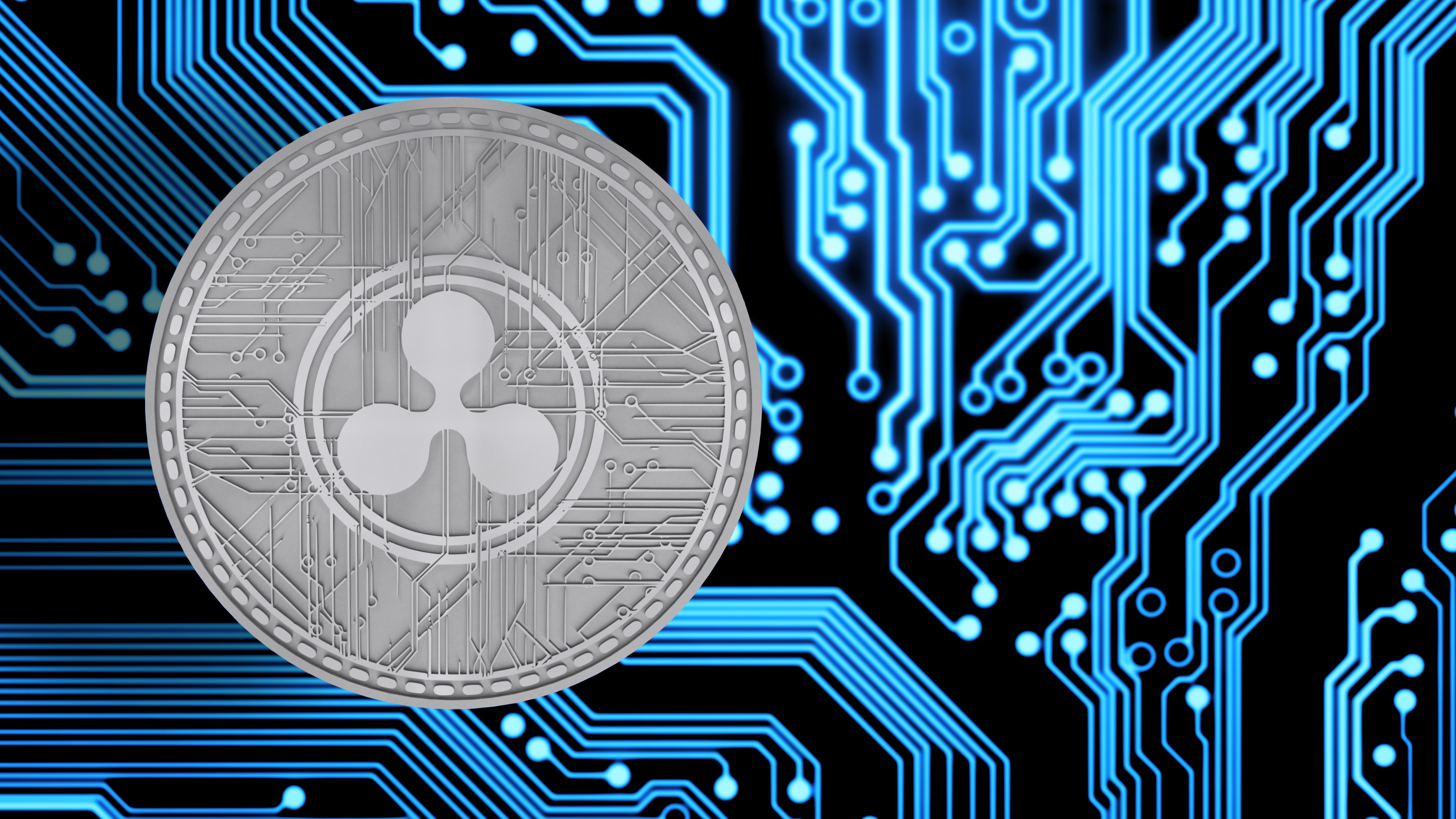 A physical silver XRP coin next to circuitry. 