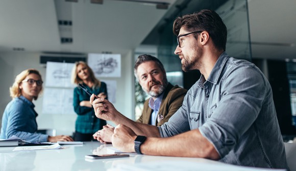 People seated around a table in an office