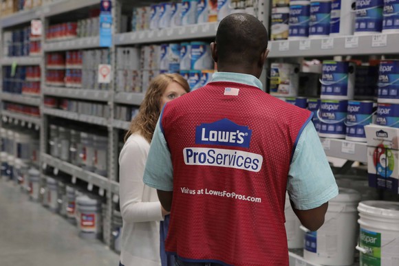 Lowe's employee helping woman in paint department
