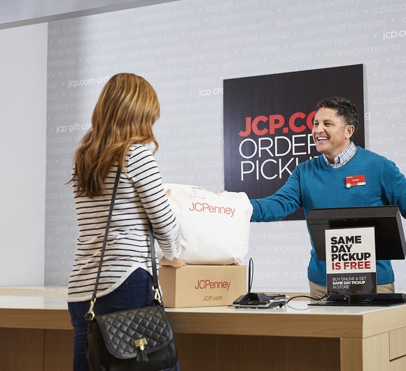 A female J.C. Penney customer talking to a male employee while claiming merchandise she ordered online