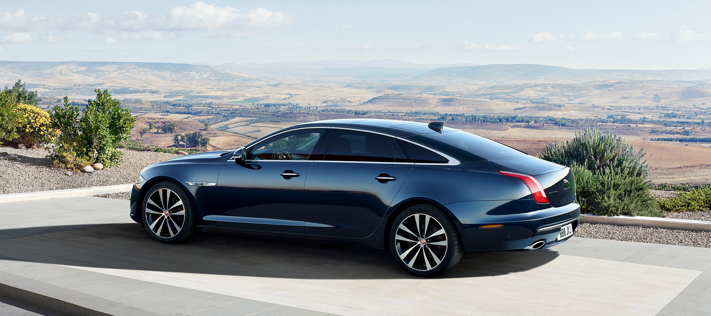 A black 2018 Jaguar XJ, a long, sleek luxury sedan.