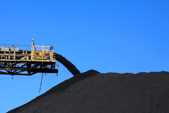 Coal being piled up from a giant conveyor.