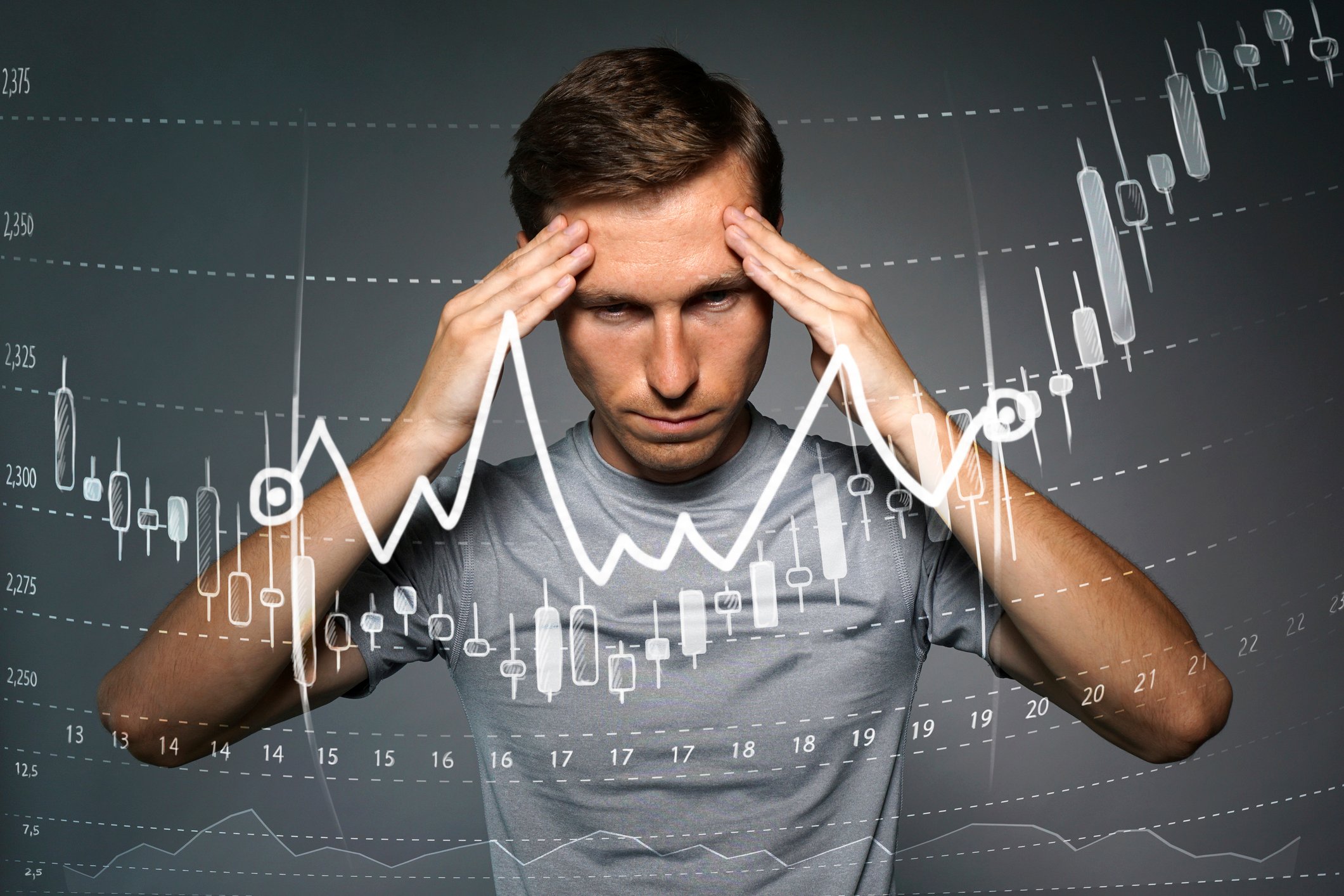 Man holding hands on forehead as in deep thought behind image of stock chart going up