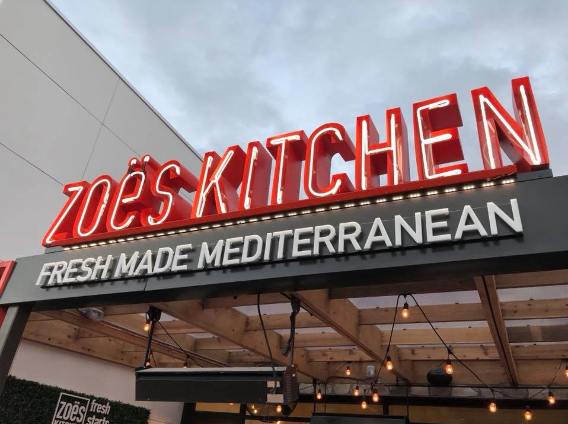 A Zoe's Kitchen restaurant sign