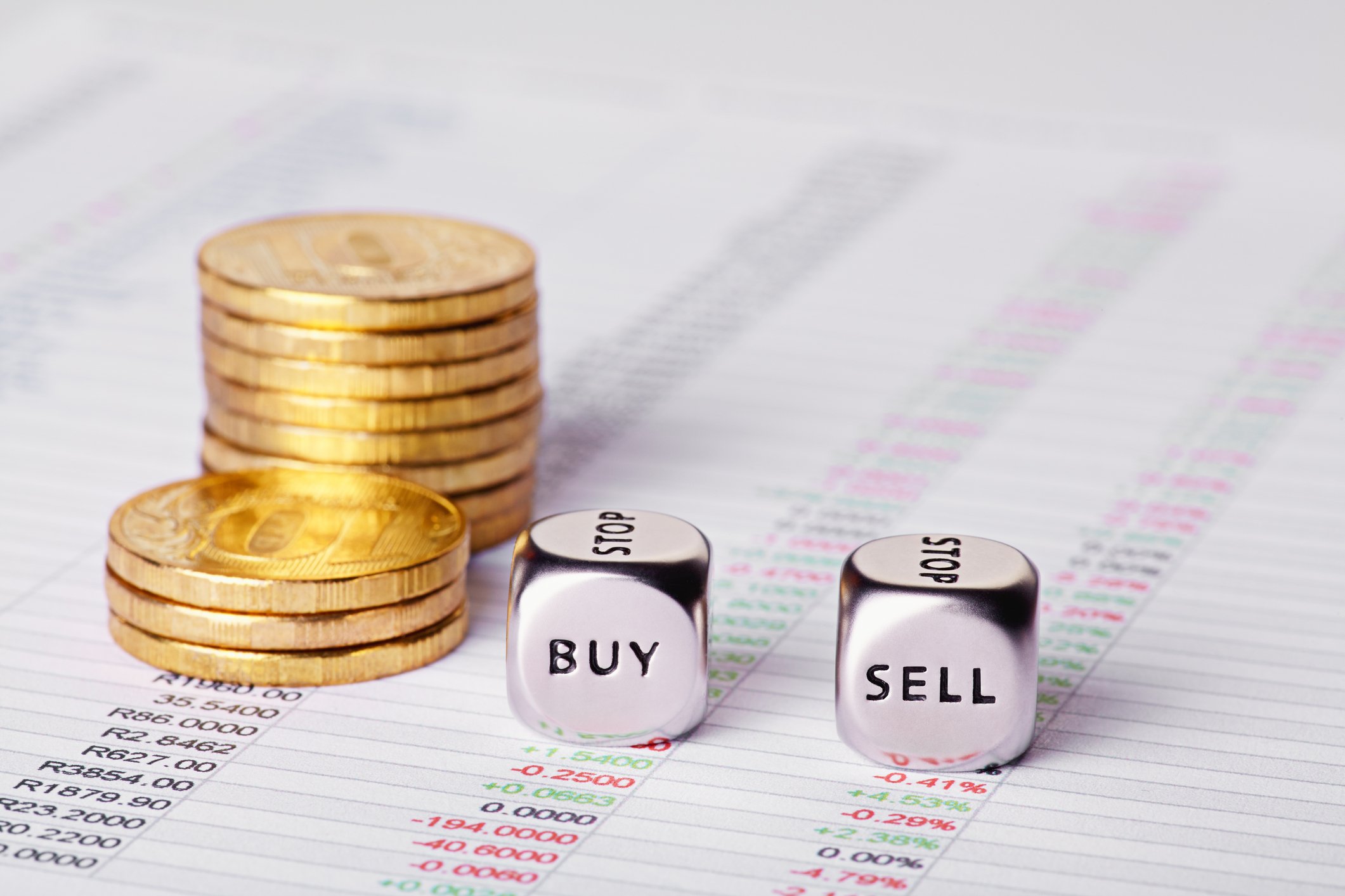 Besides a stack of gold coins, a pair of dice say buy and sell.
