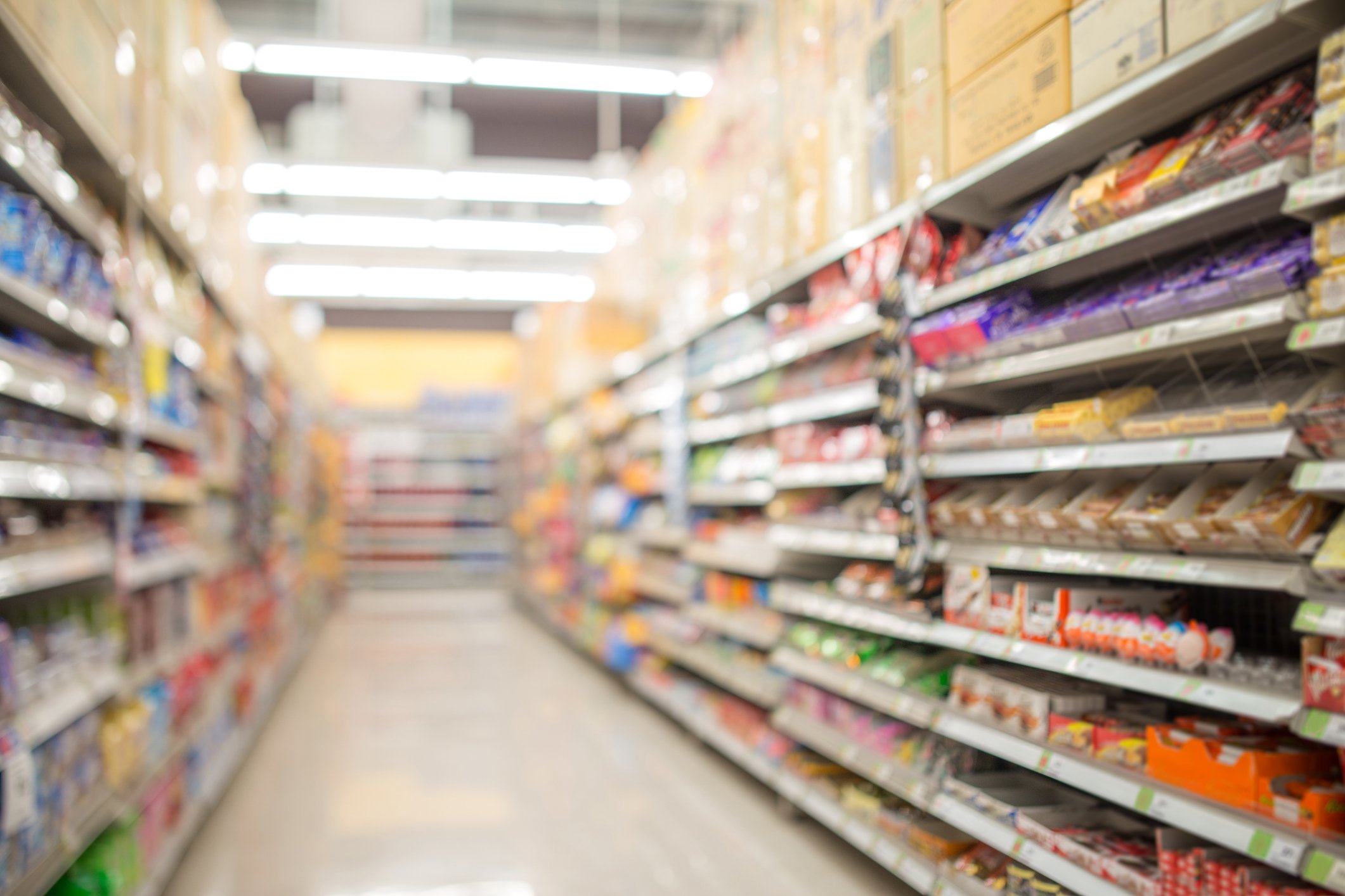 A look at products down an aisle of a retail store.