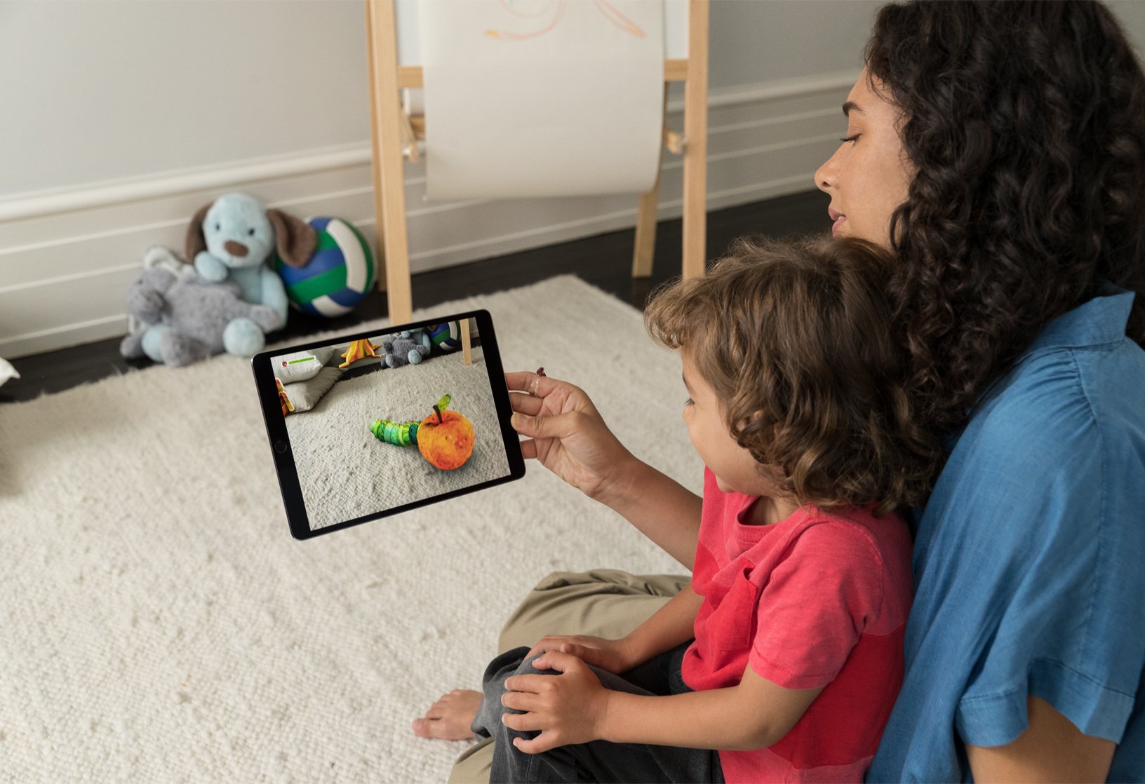 A mom using augmented reality apps with her child