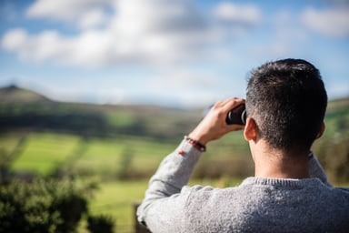 Binoculars man looking forward