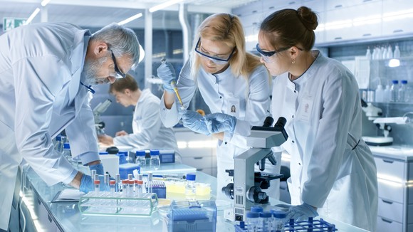 Four scientists in lab performing research