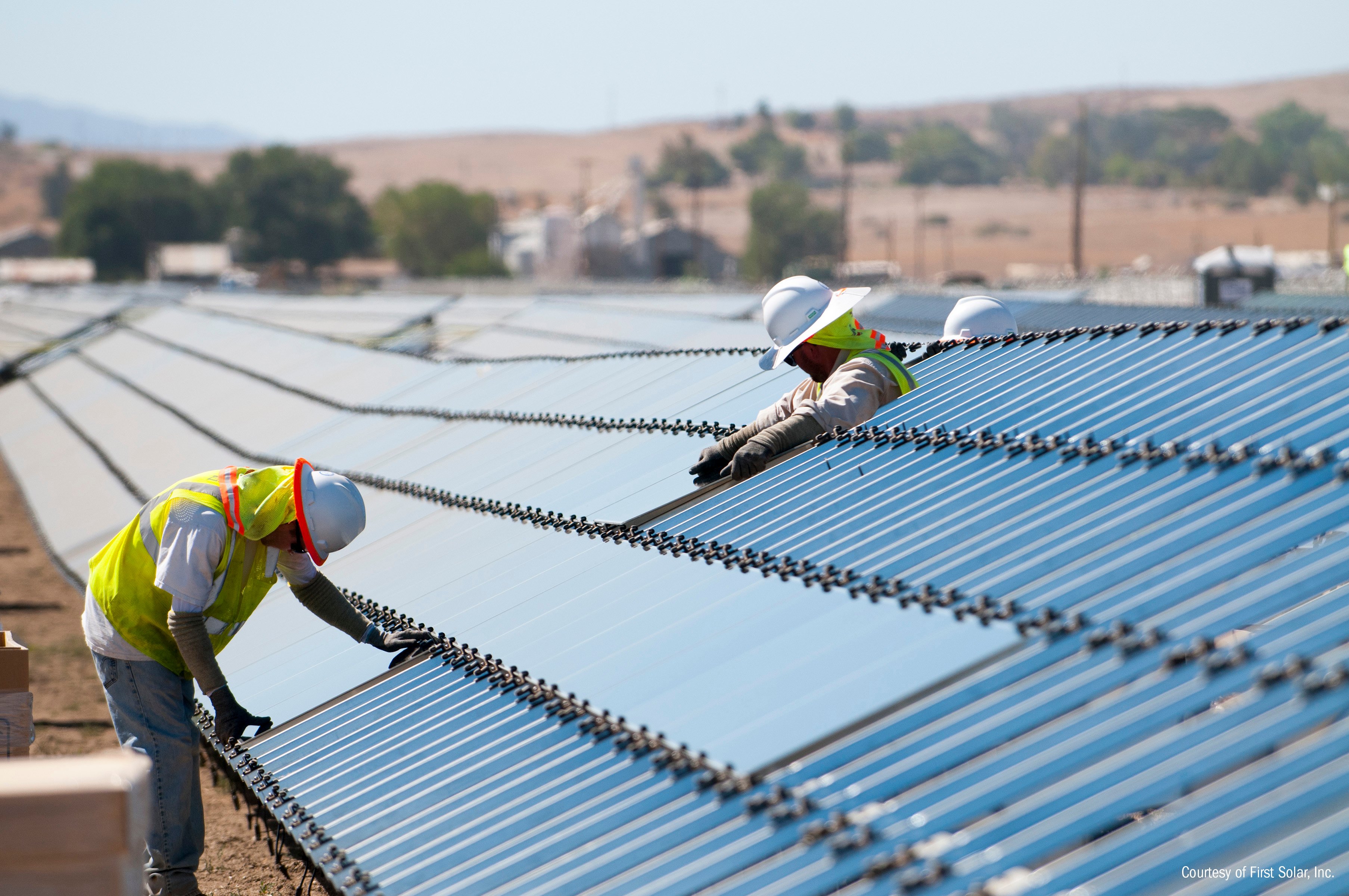 Workers installing solar panels. 