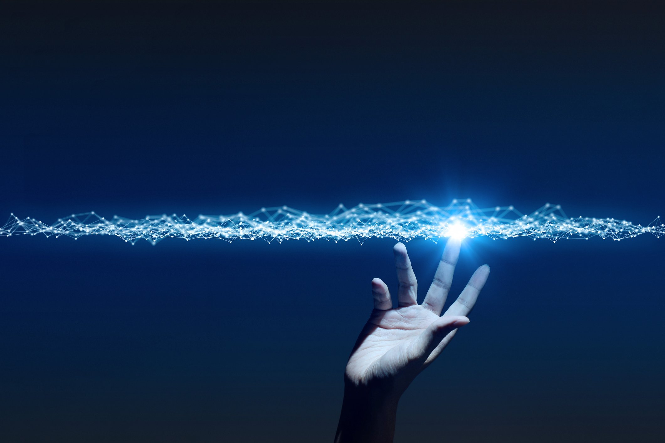 Hand reaching up and touching a line of light.