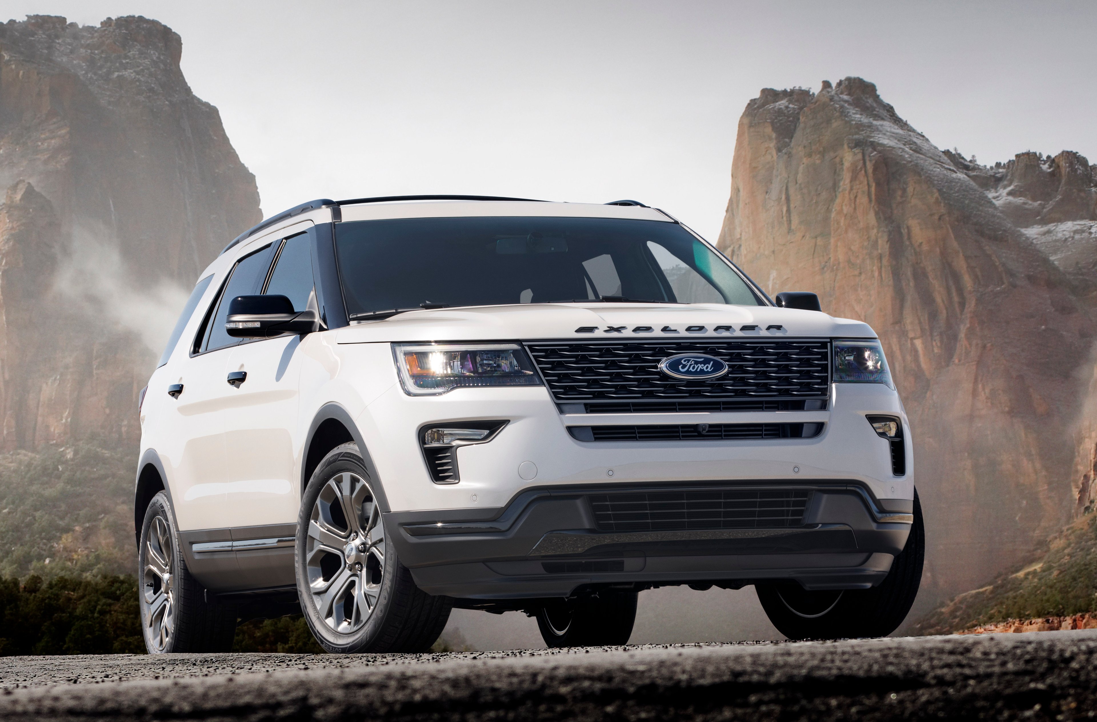 A white 2018 Ford Explorer, a midsize crossover SUV.