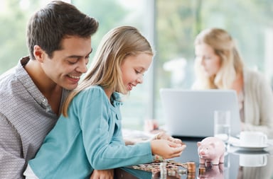 Getty Father Watches Daughter Count Coins