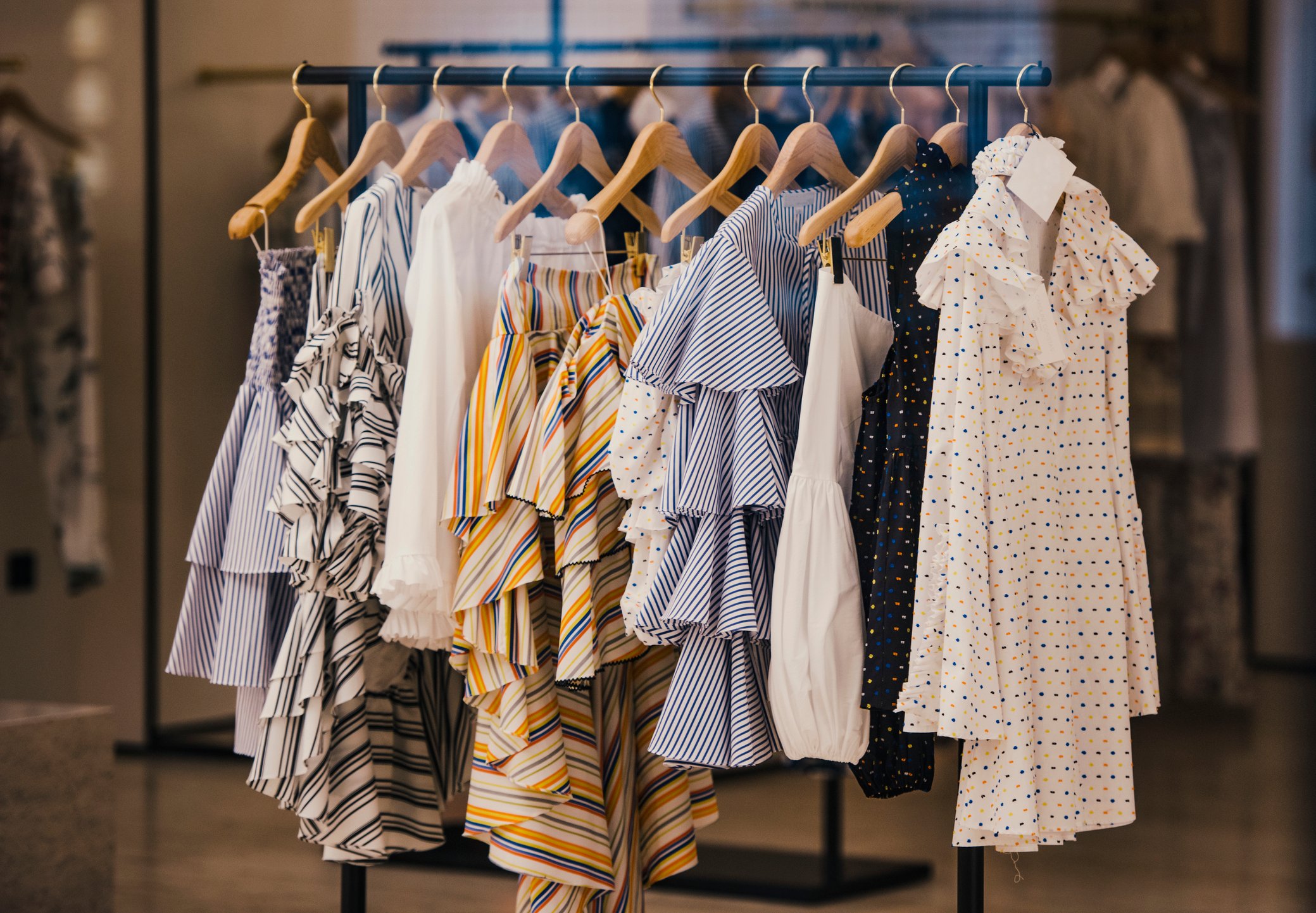 Women's tops hanging on a rack in a store