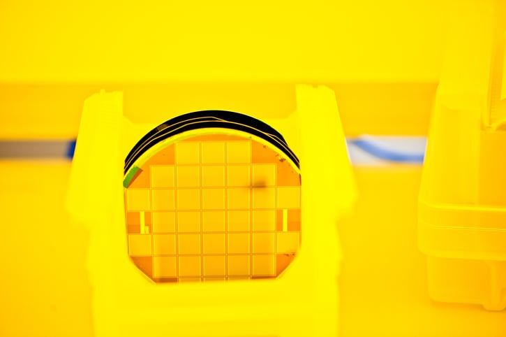 Closeup of a golden silicon wafer in a clean-room testing environment