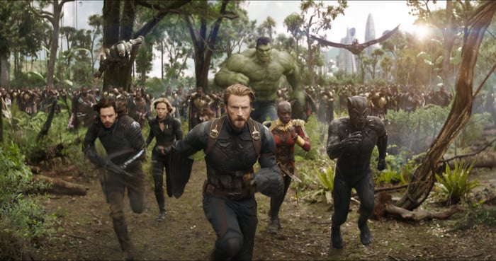 A group of Avengers, led by Captain American, charges toward an unseen villain.