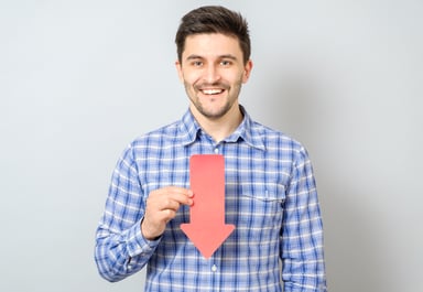 Man smiling and holding arrow pointing down