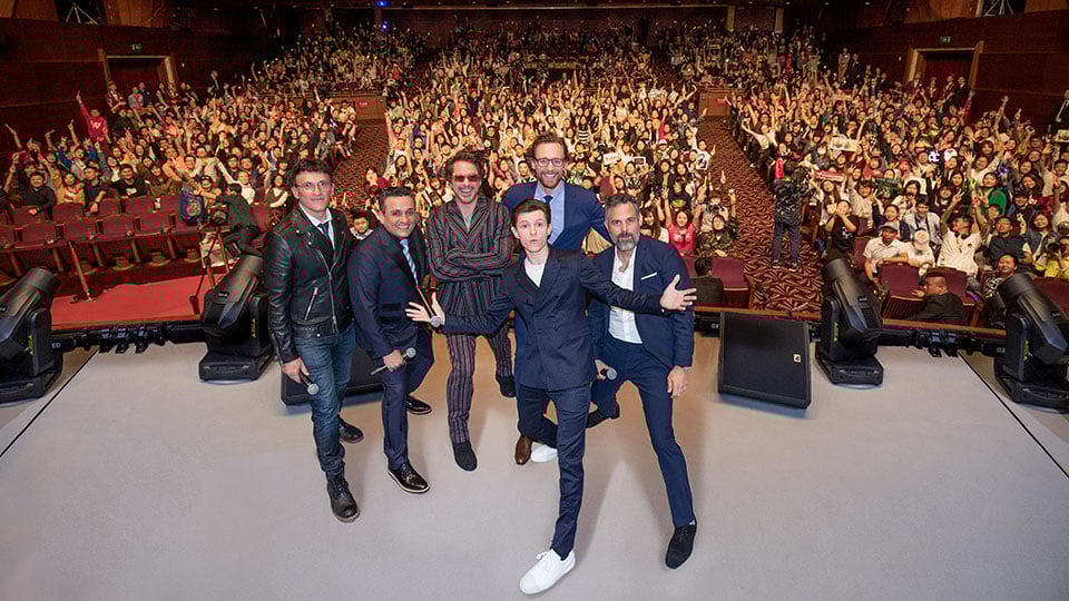 Avengers: Infinity War cast posing for a photo in front of an audience at the Shanghai Disney Resort.