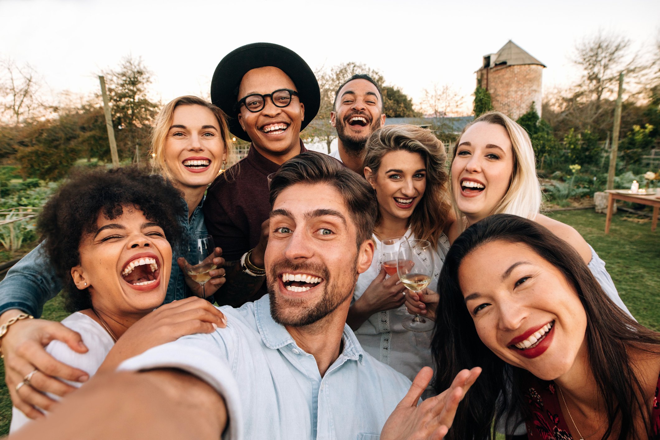 Group of young adults posing and smiling for a group photo