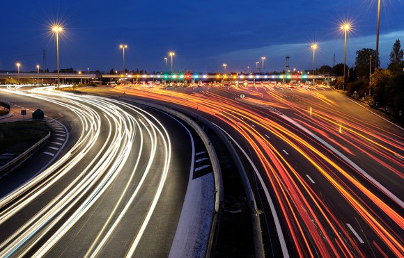 A long-exposure picture of a toll road at night