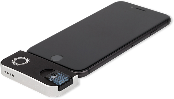 A smartphone with a SmidgION prototype attached.