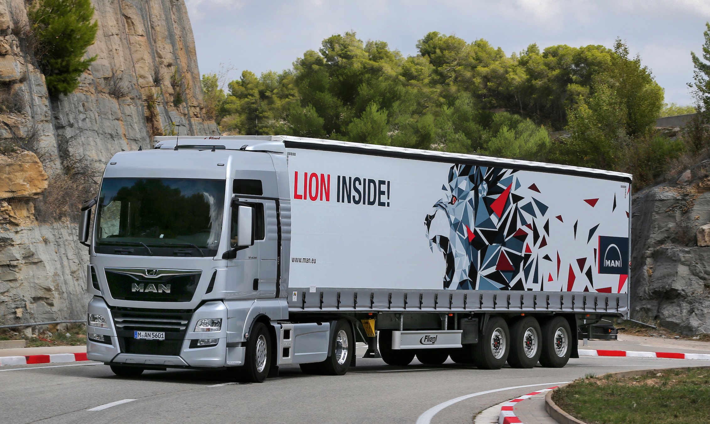A MAN tractor-trailer truck on a mountain road.