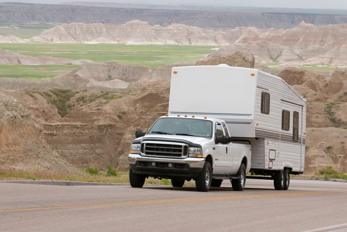 An RV being towed by a truck.