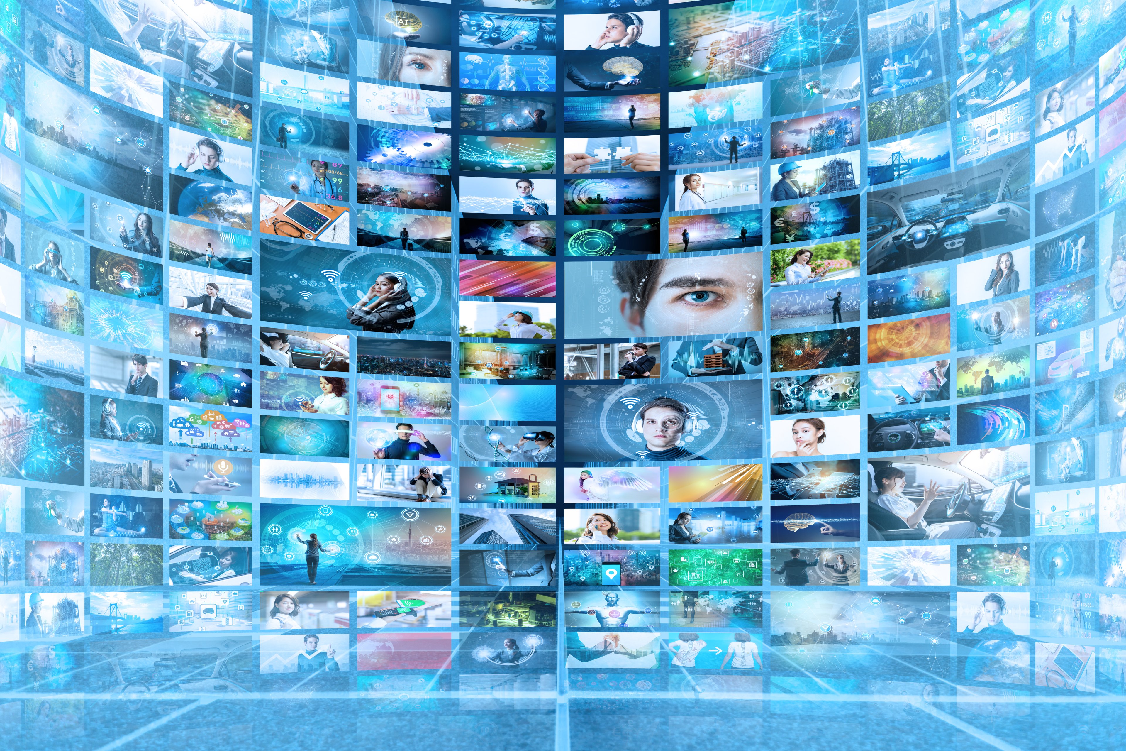 A wall of televisions showing various images.