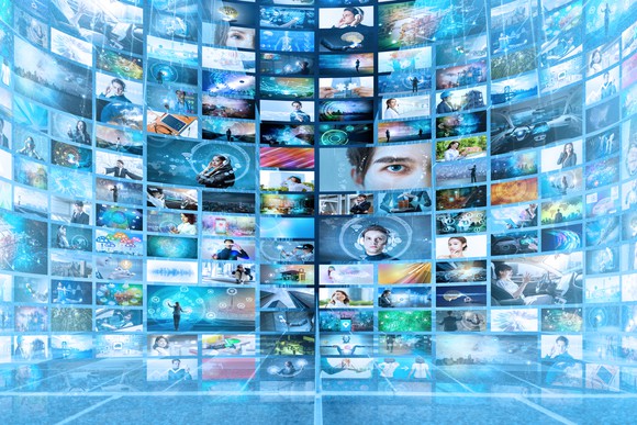 A wall of televisions showing various images.