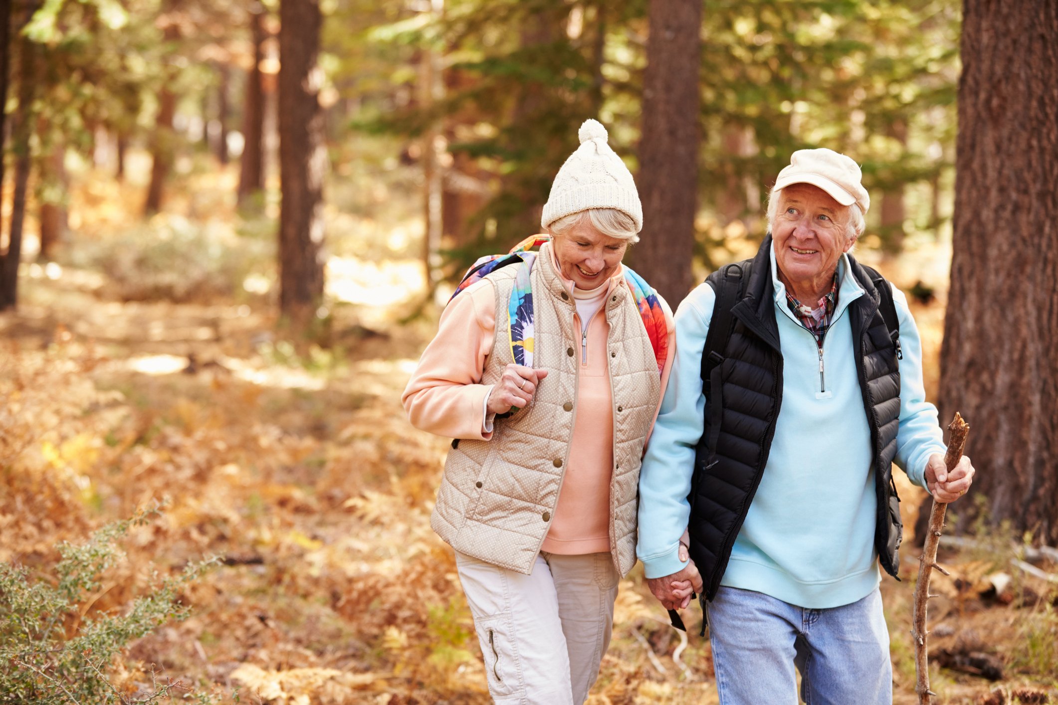Senior couple walking through a wooded area
