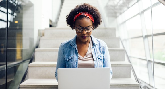 A woman using a laptop.