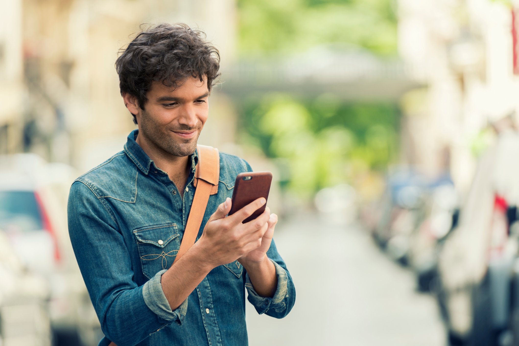 A young man checks his smartphone.