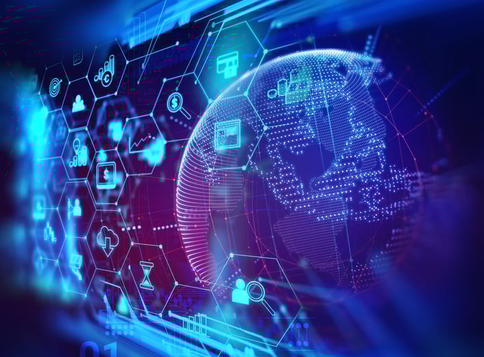 A digital globe overlaid with a variety of luminescent technology icons.