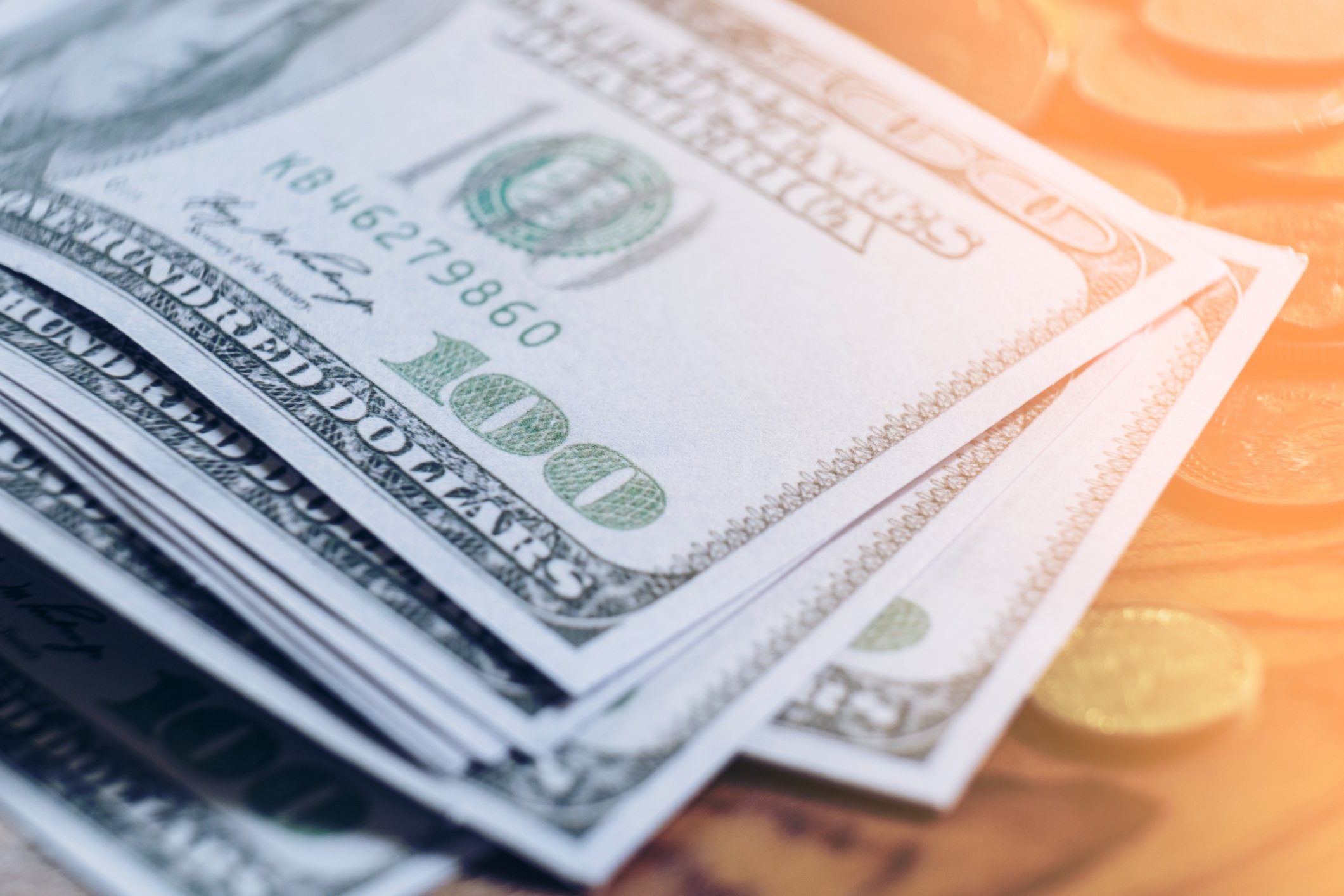 Image of one hundred dollar bills on a table.