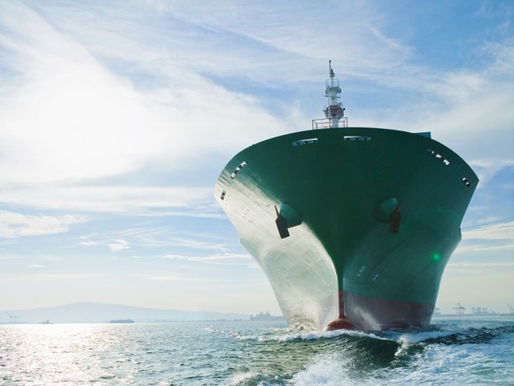 Bow view of cargo ship sailing on ocean.
