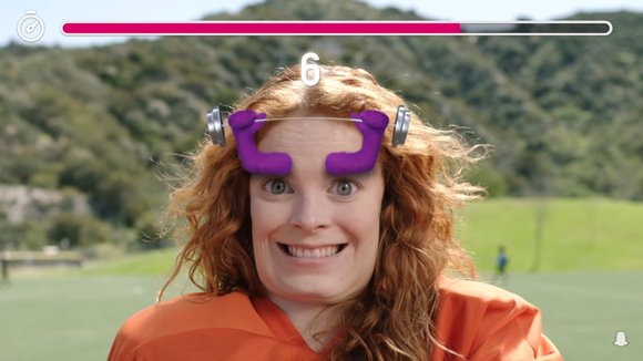 A woman playing a Snappable Snapchat game.