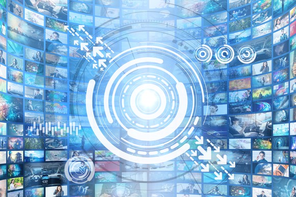 A digital illustration of a lens in front of a huge collection of screens.