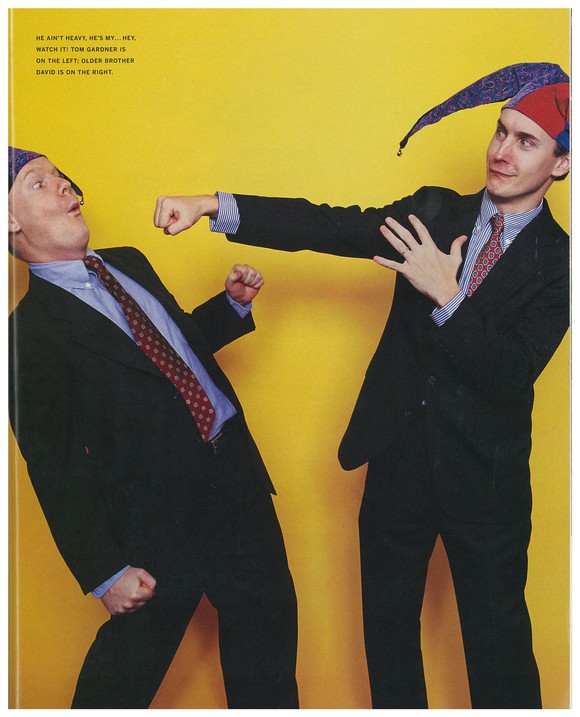 Two men in jester hats and suits, one fake-punching the other.