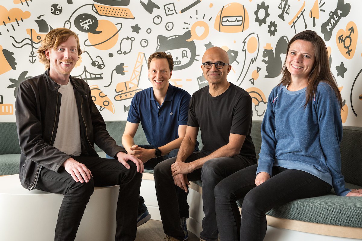 The co-founder of GitHub, sitting with three executives from Microsoft at GitHub headquarters