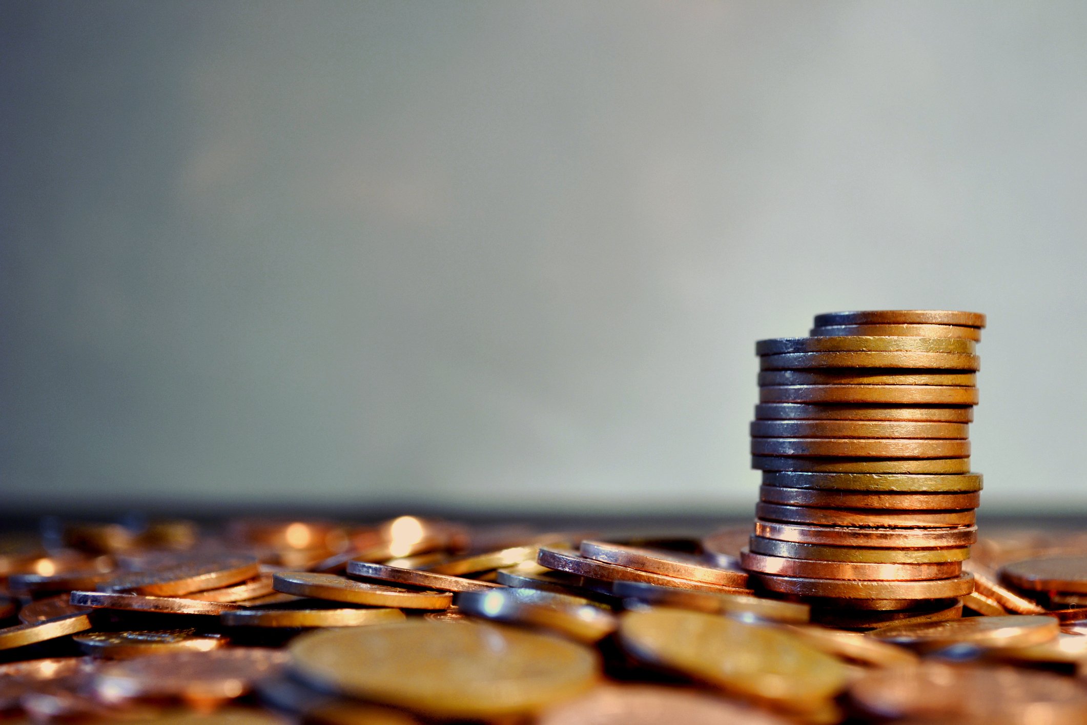 A pile of pennies with a stack of pennies on top.