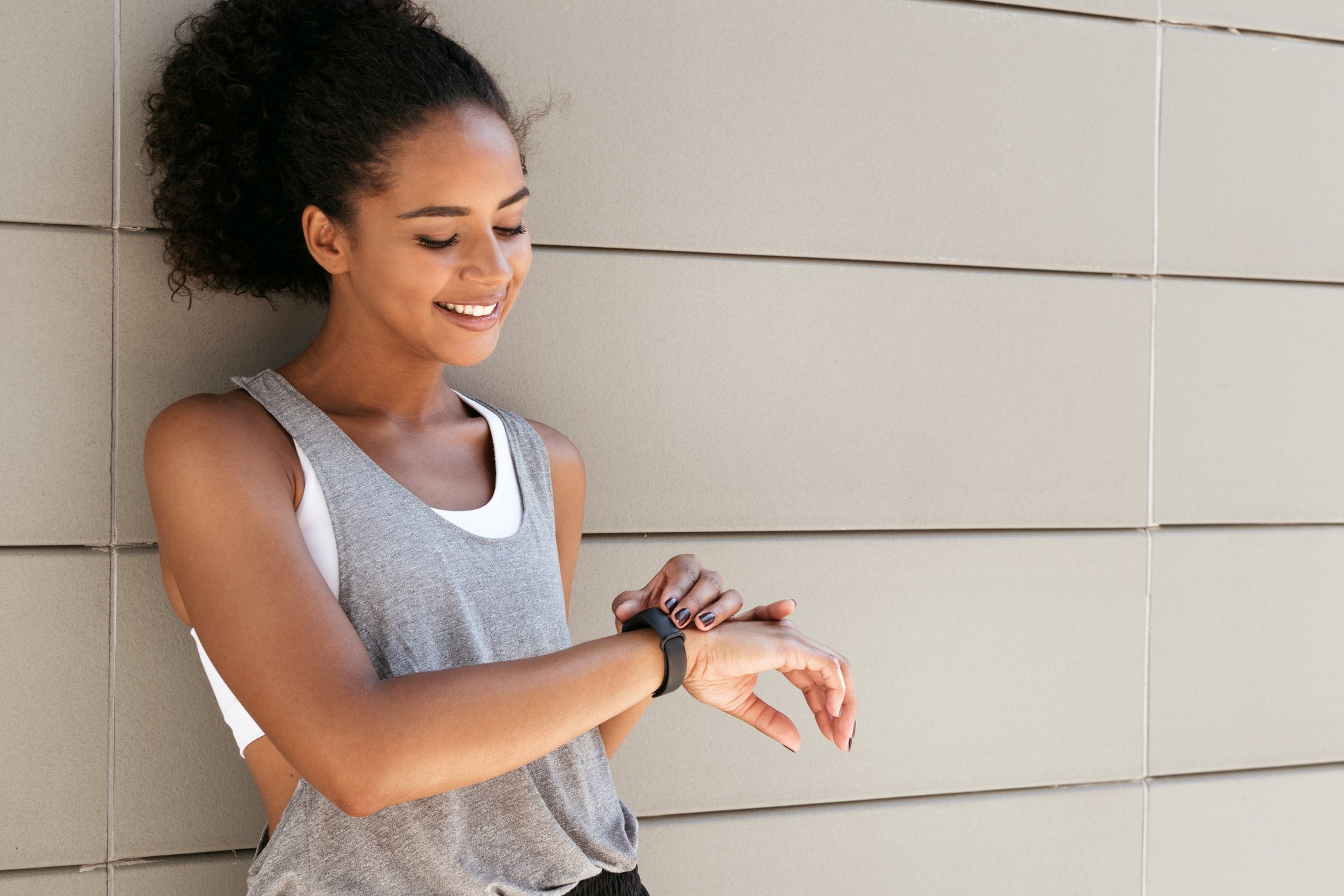 A woman checks her fitness tracker.