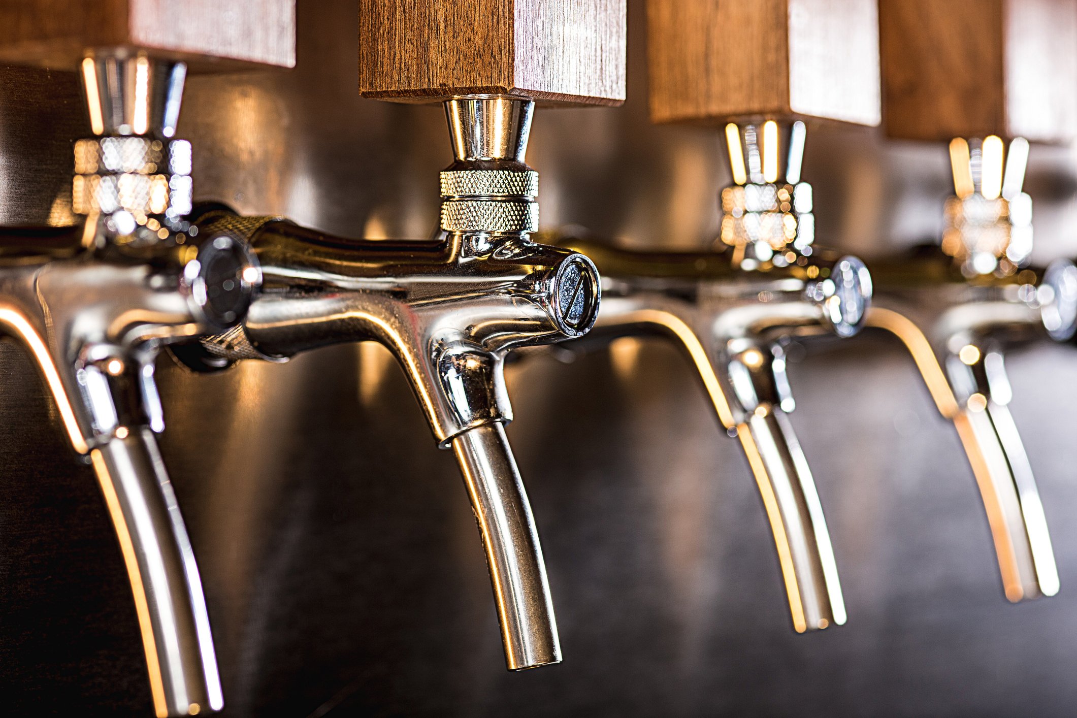 Close-up of row of beer taps in a pub.