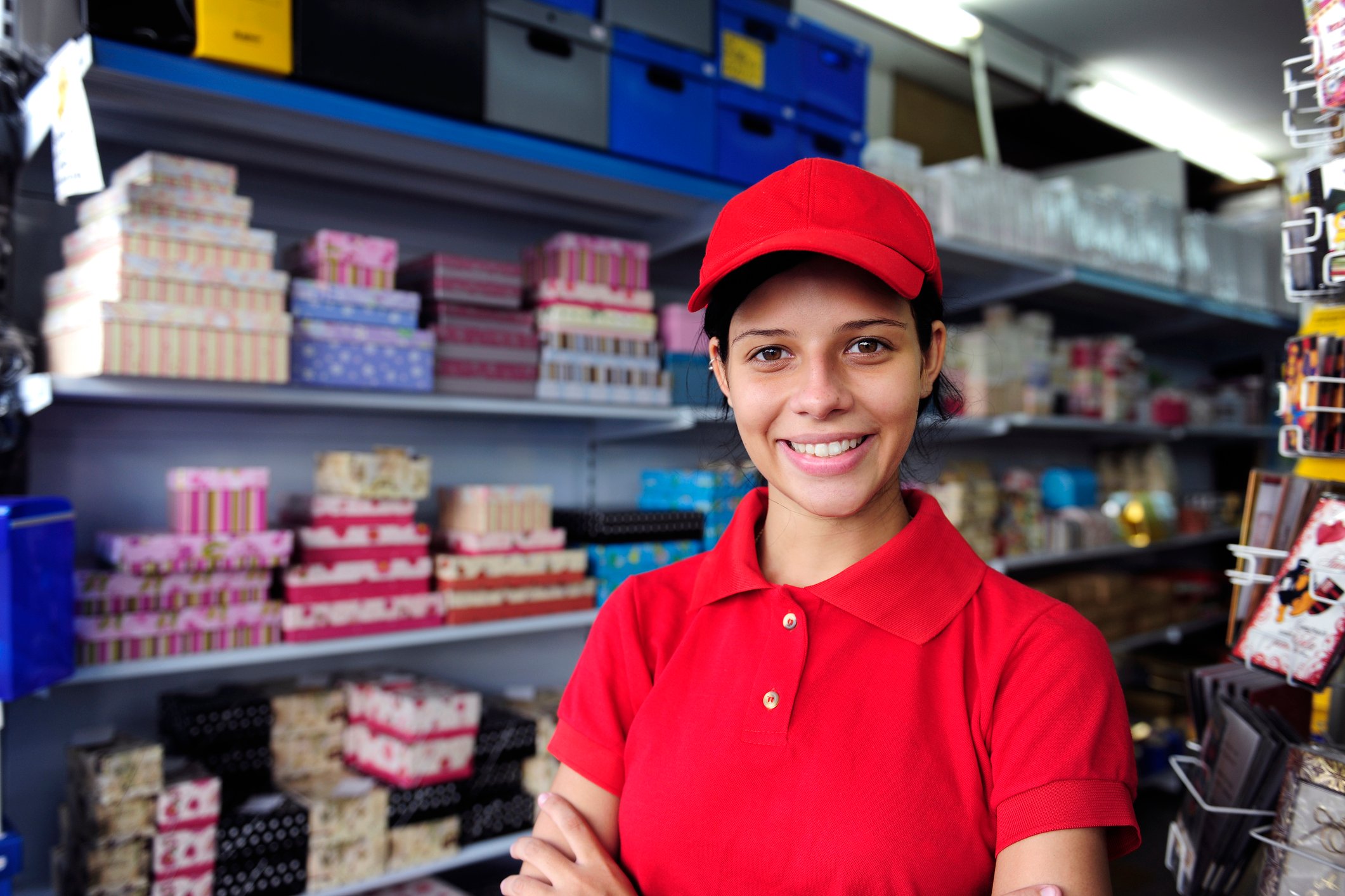 A teenager is working in a retail store.