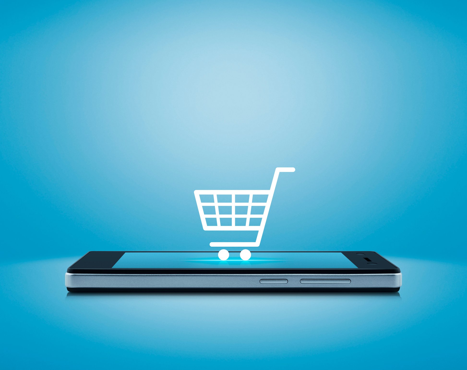 A shopping cart icon on top of a mobile phone.
