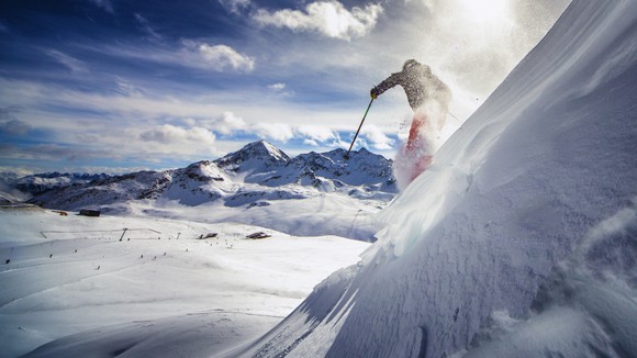 Skier skiing down a mountain. 