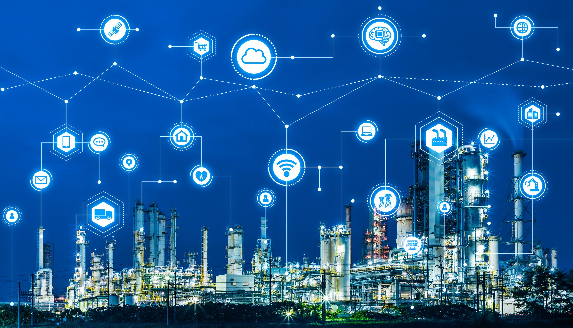 A connected collection of icons representing things including transportation, cloud software, wireless internet, and industry above a factory. 