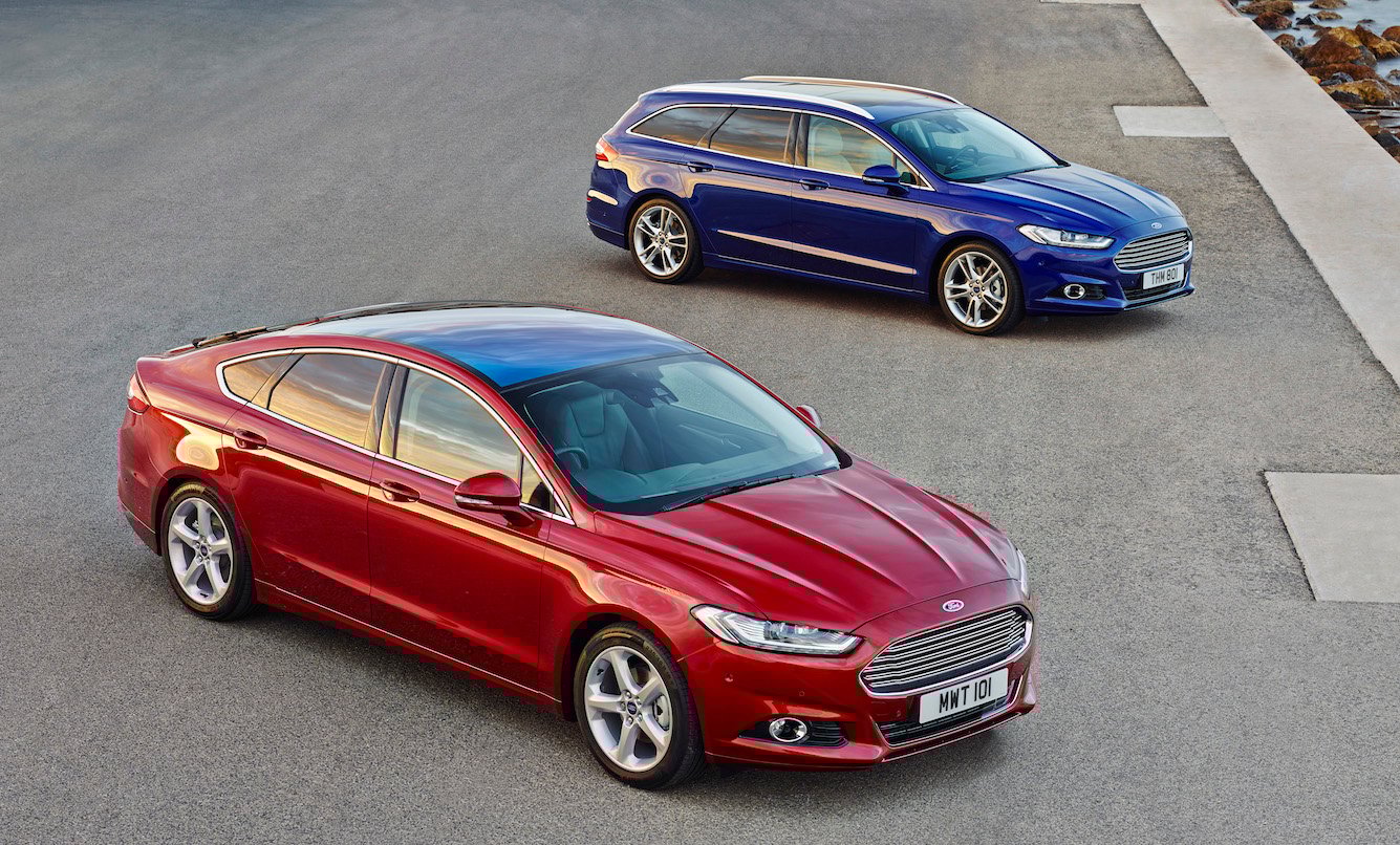 Two Ford Mondeos: A red five-door and a blue station wagon. Aside from the body-style changes, they look almost exactly like the Fusion sedan sold in the United States. 