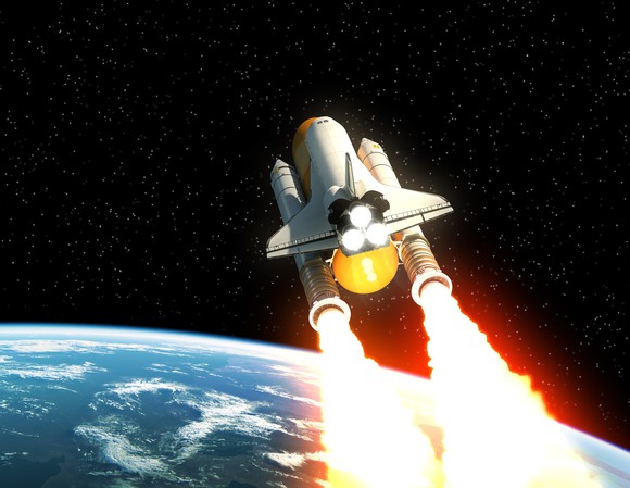 Space shuttle flying over Earth