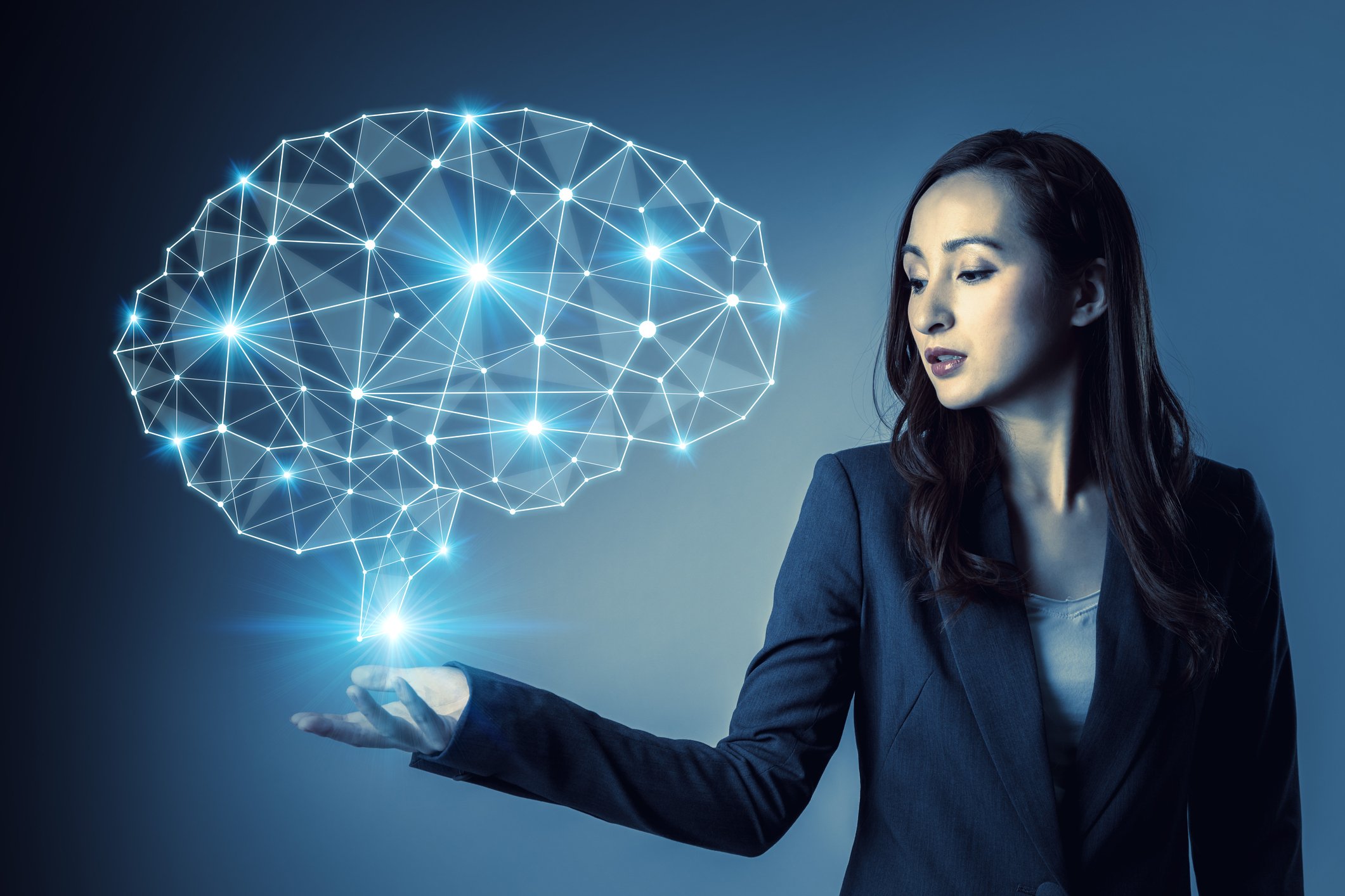 A series of lights shaped like a human brain float above a woman's upturned palm.