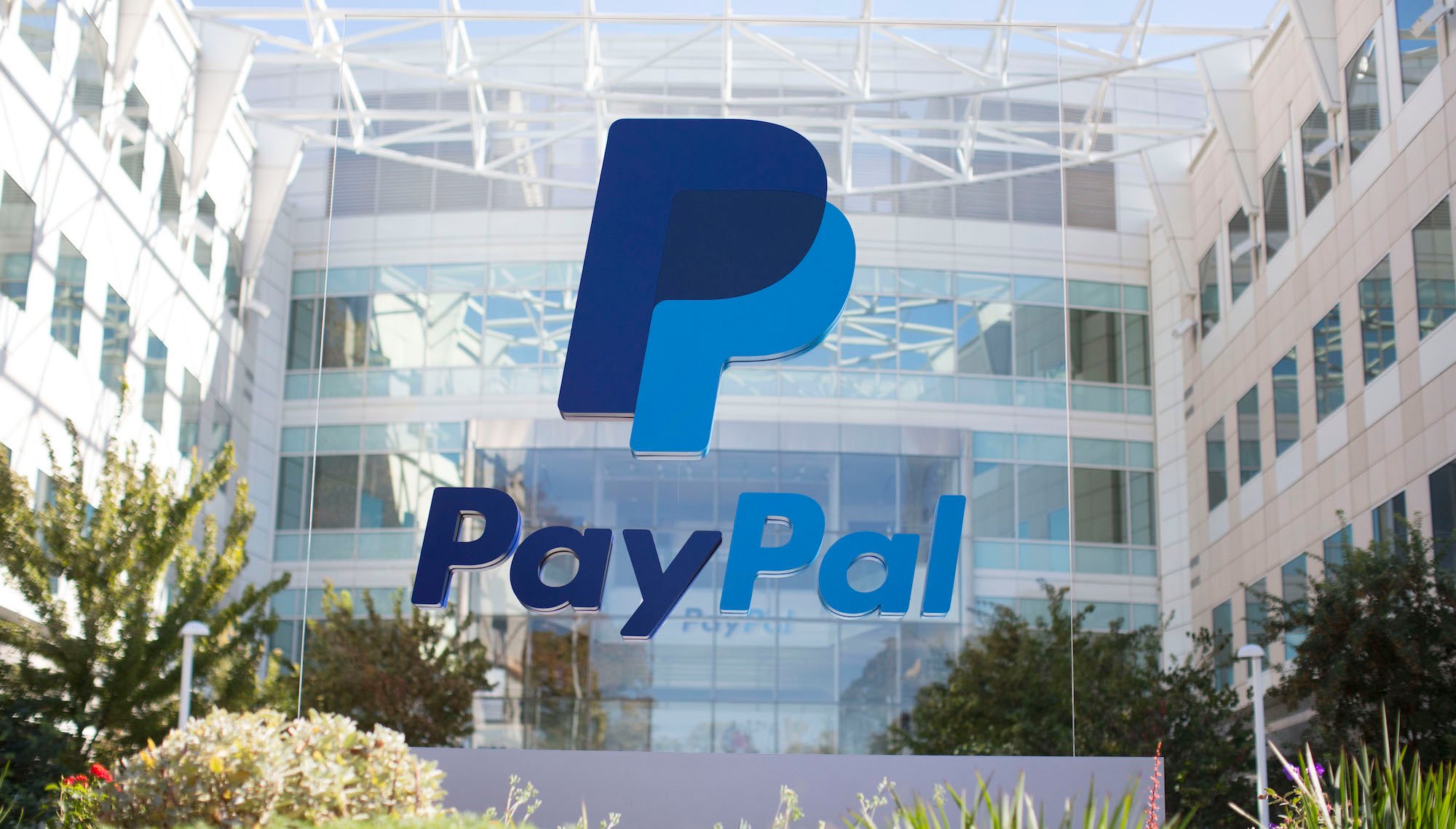 A PayPal building with the PayPal logo on a sign in front of it.